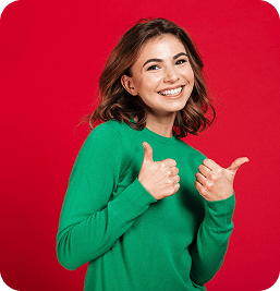 Woman in green sweater giving thumbs up